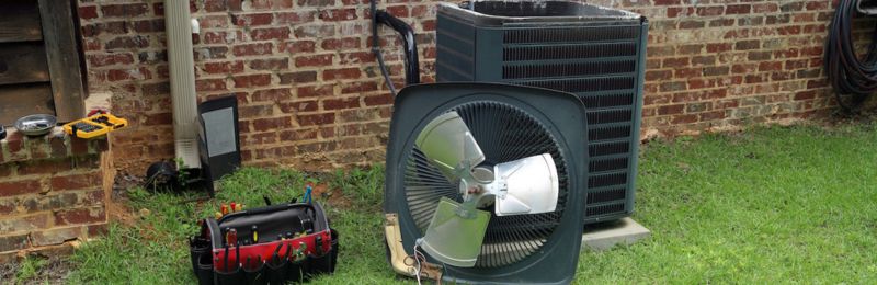Technician completing a Phoenix AC tune up on an outdoor condenser unit