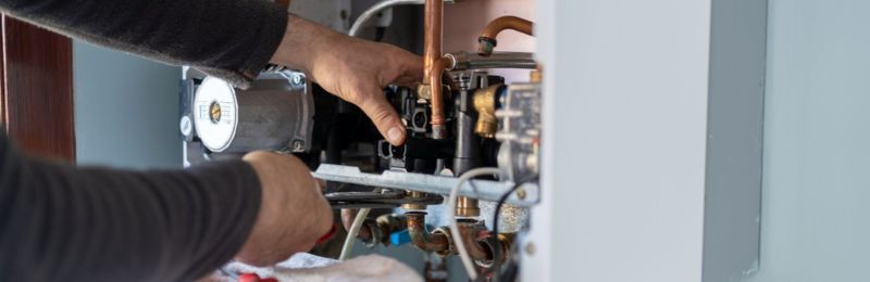 Furnace technician repairing a heating system in Phoenix AZ